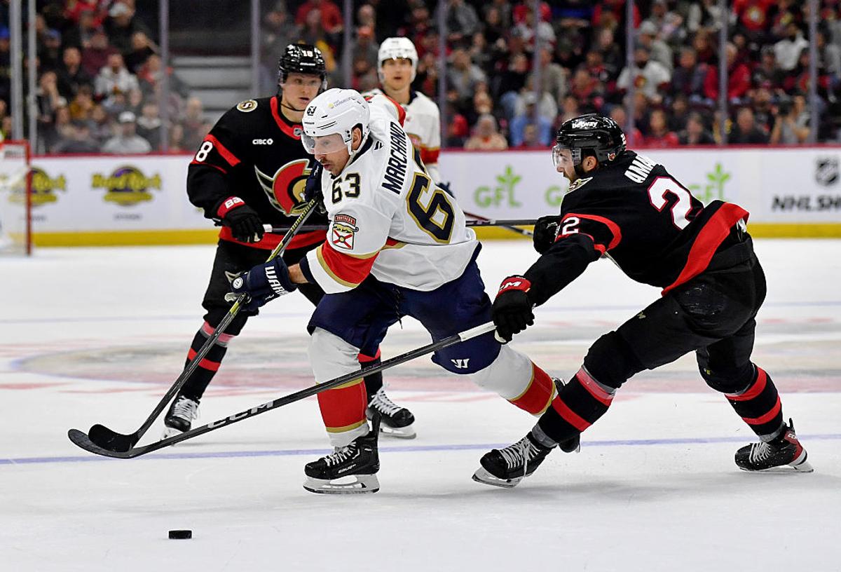Brad Marchand and Tim Stutzle in the background