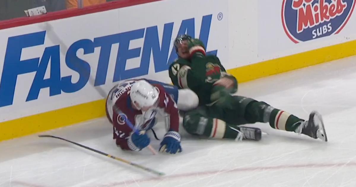 Manson drives the butt-end of his stick toward McCarron