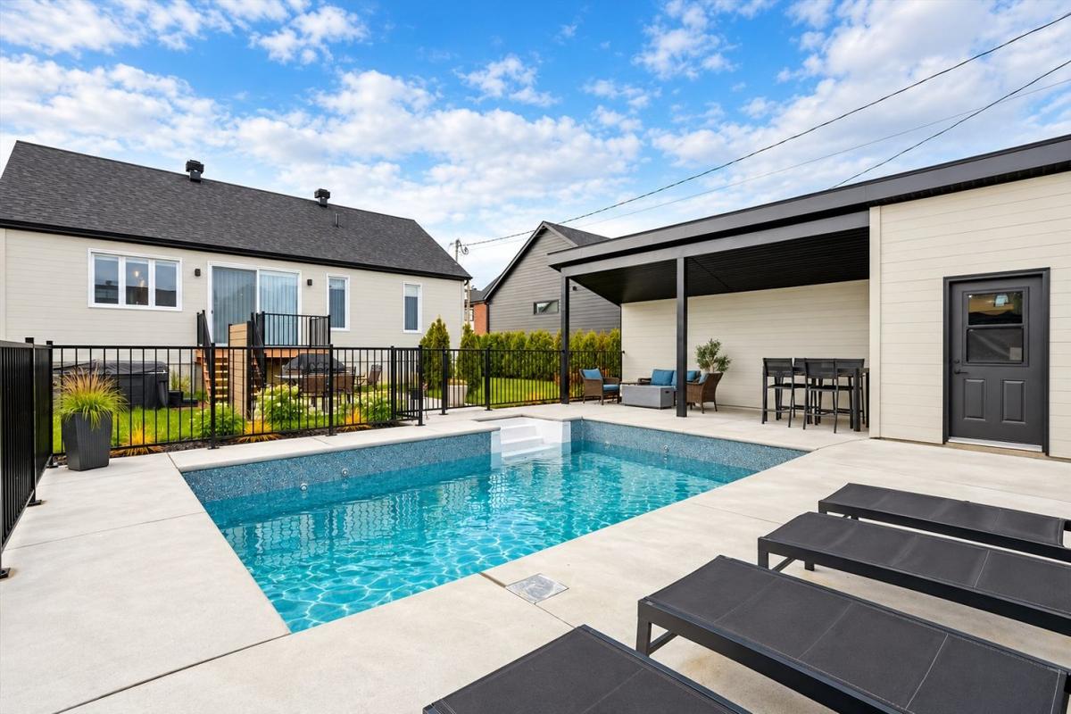Vue de la piscine creusée et de la terrasse arrière